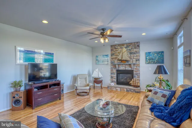 a view of staircase and living room with wooden floor
