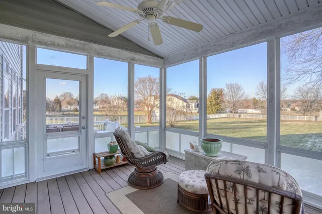 a bedroom with a bed a dresser and a chandelier