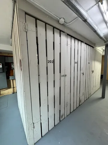 a view of a hallway with wooden walls