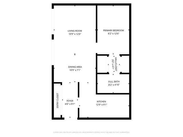 a picture of a bench in front of a wall