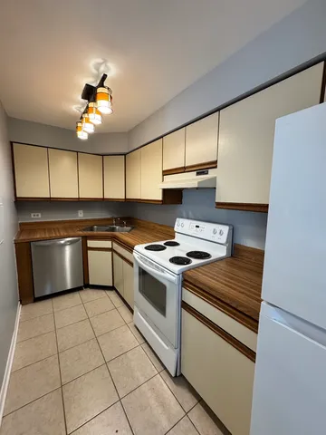 a kitchen with cabinets appliances and a window
