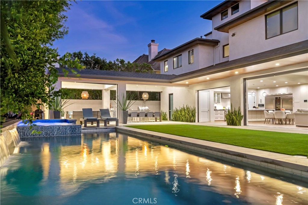 660 Kings Road Newport Beach, CA 92663 - Photo 38 of 41 a swimming pool view with a seating space and a garden view