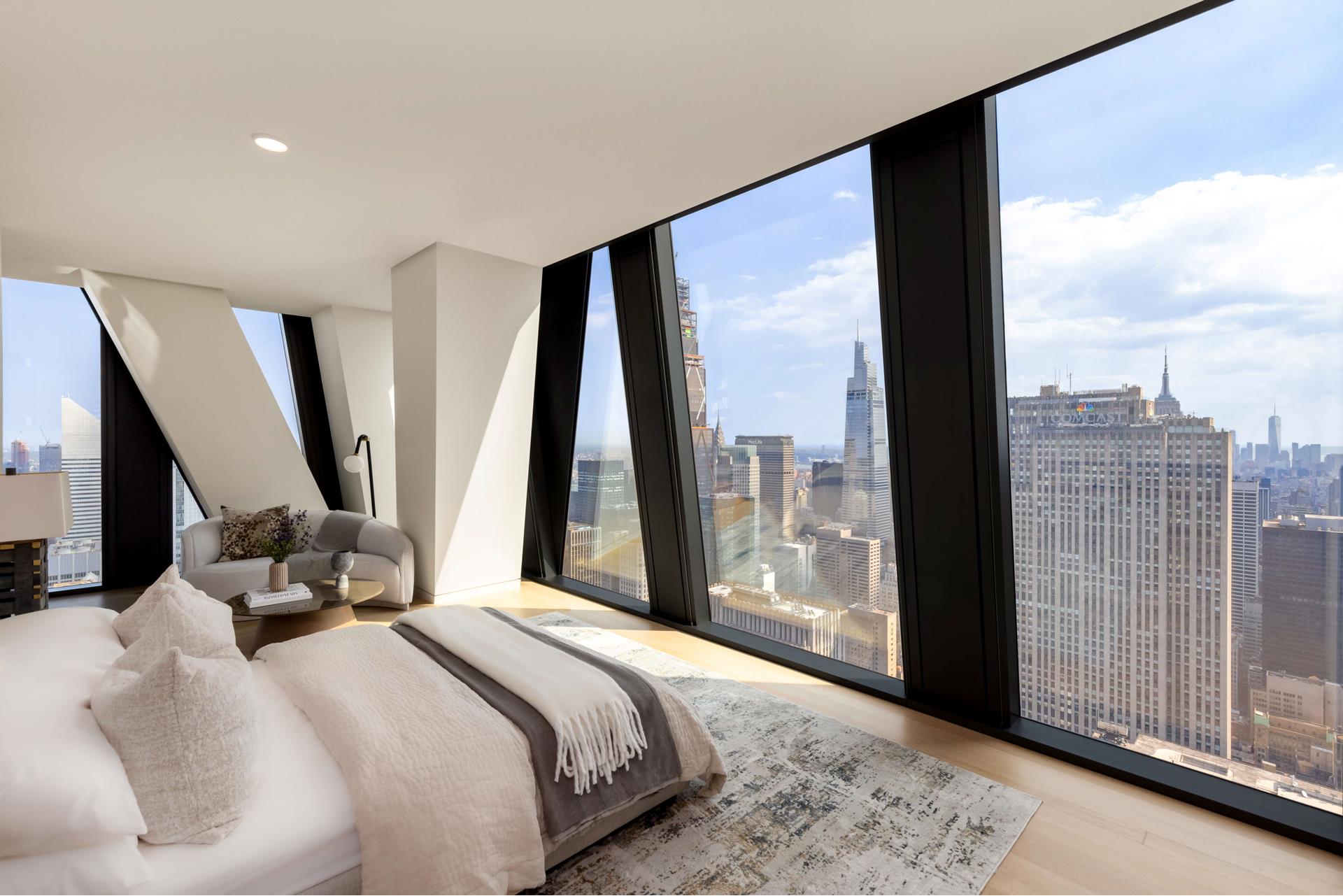 53 West 53rd Street, Unit 72B Manhattan, NY 10019 - Photo 9 of 39 a bedroom with a bed and a large window