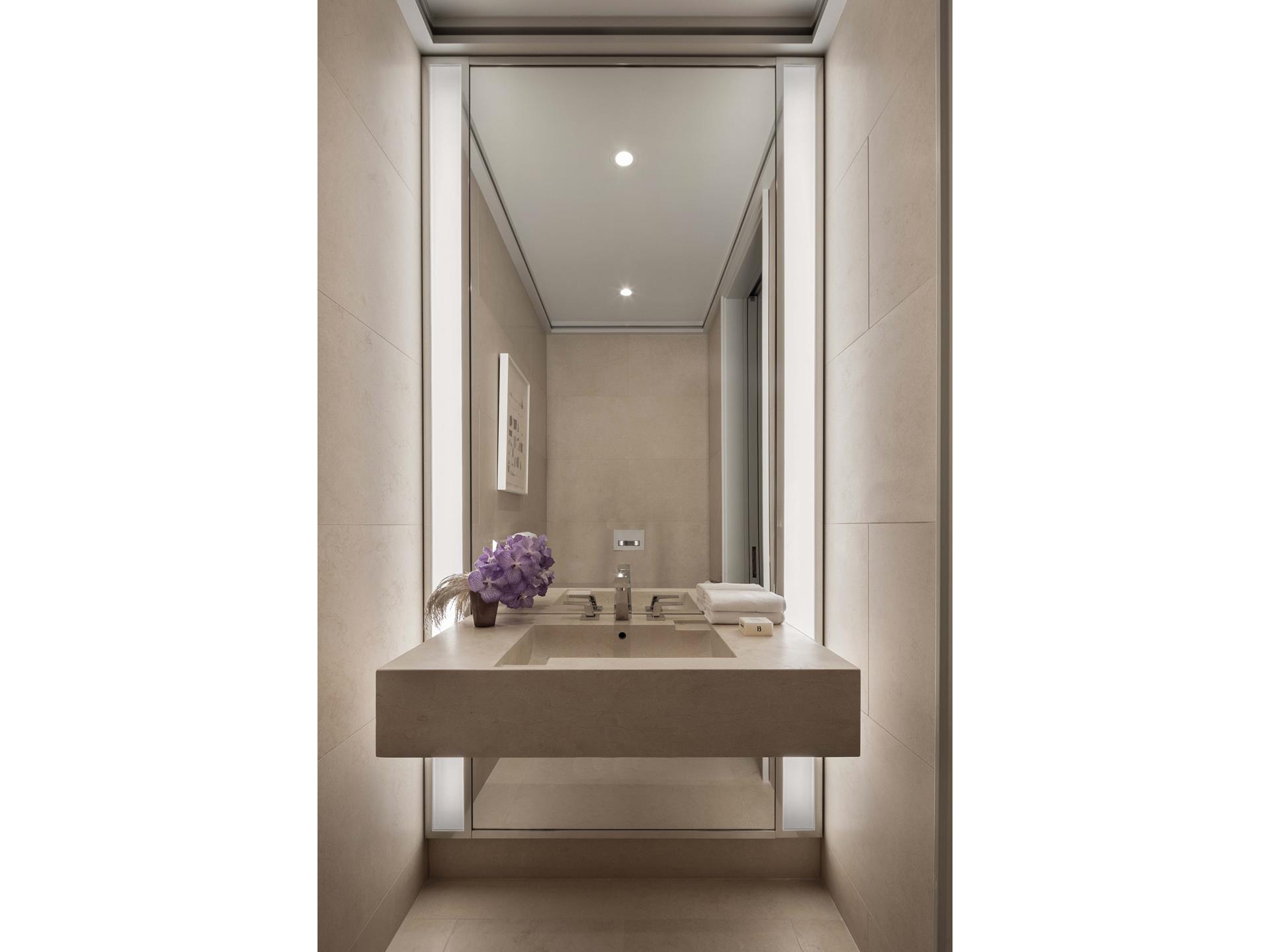 53 West 53rd Street, Unit 72B Manhattan, NY 10019 - Photo 11 of 39 a bathroom with a sink and a mirror