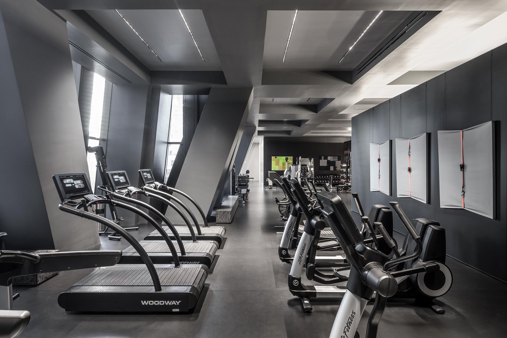 53 West 53rd Street, Unit 72B Manhattan, NY 10019 - Photo 19 of 39 a room with gym equipment