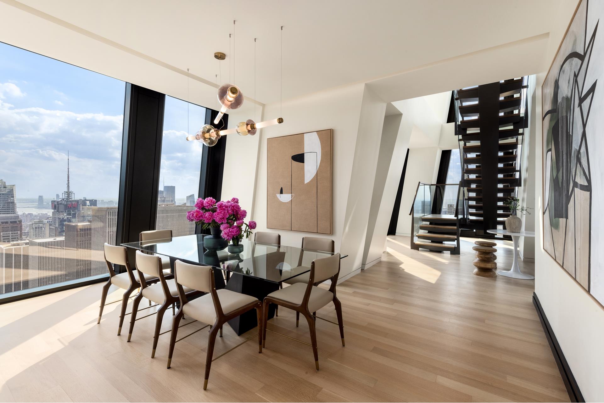 53 West 53rd Street, Unit 72B Manhattan, NY 10019 - Photo 4 of 39 a view of a dining room with furniture and wooden floor