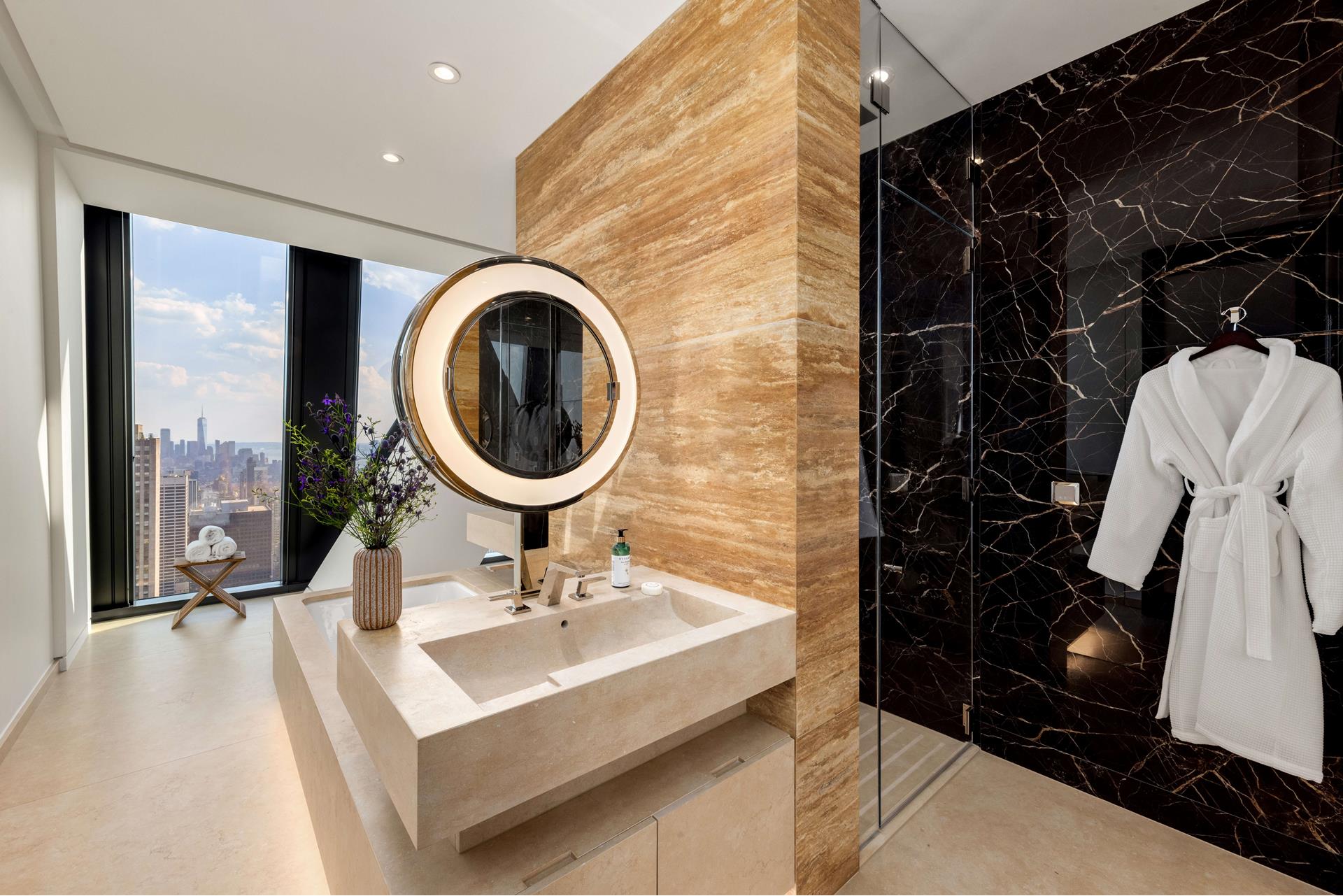 53 West 53rd Street, Unit 72B Manhattan, NY 10019 - Photo 8 of 39 a bathroom with a sink a mirror and a shower