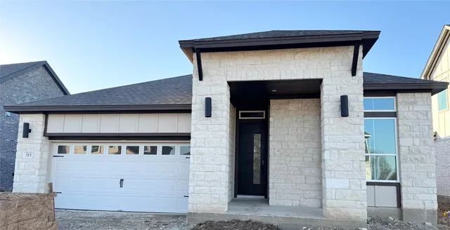a front view of a house with white wall