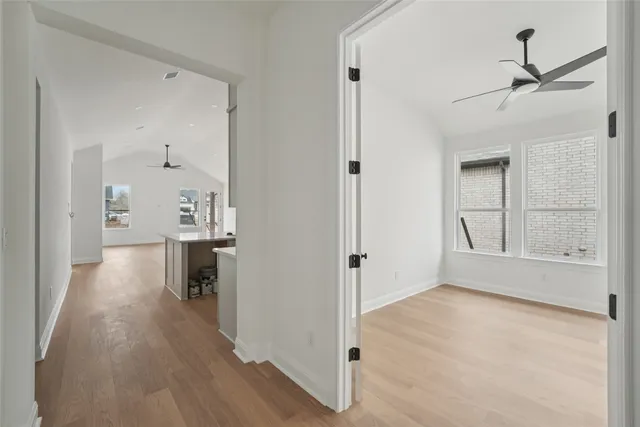 a view of a kitchen with wooden cabinet and a window