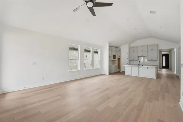 a kitchen with a sink stove and cabinets