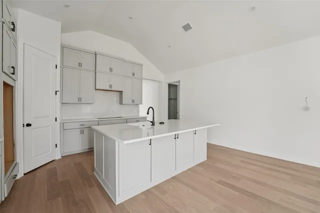a kitchen with cabinets a sink and a stove