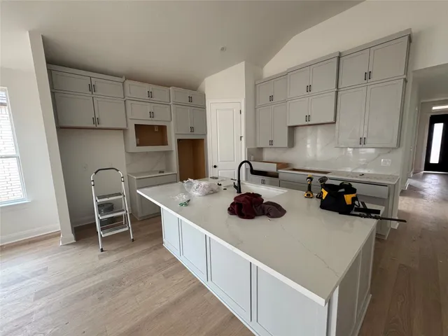 a kitchen with a stove a sink and a refrigerator