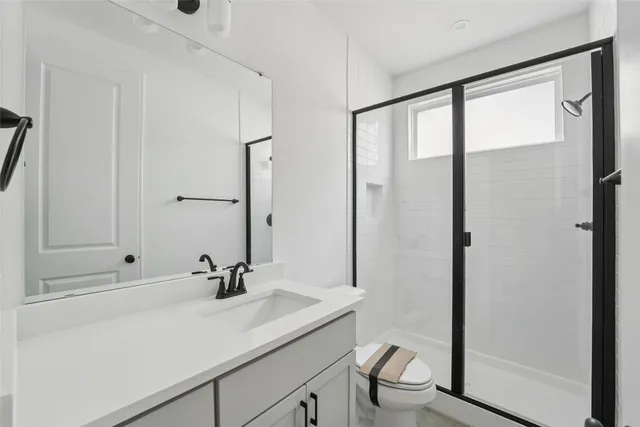 an empty room with a window and a ceiling fan