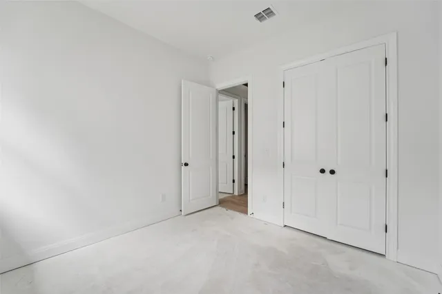 a spacious bathroom with double sink and a mirror