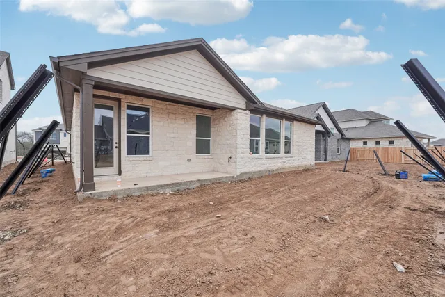 a view of a house with a backyard