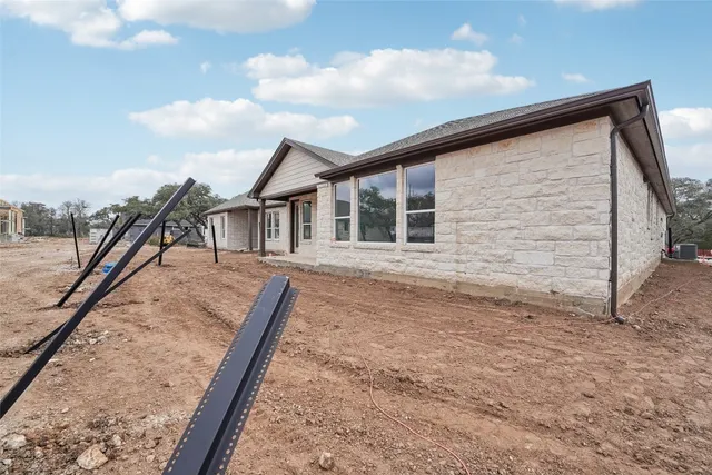 a view of a house with backyard and deck