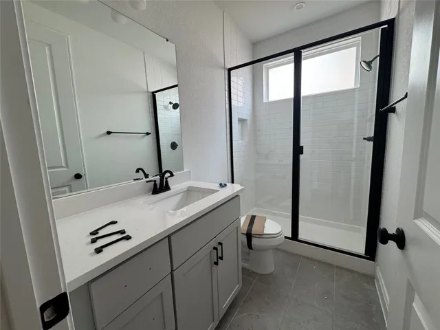 a bathroom with a double vanity sink a mirror and a shower