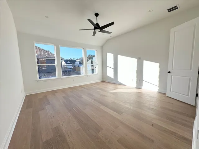 a view of a livingroom with a ceiling fan and window