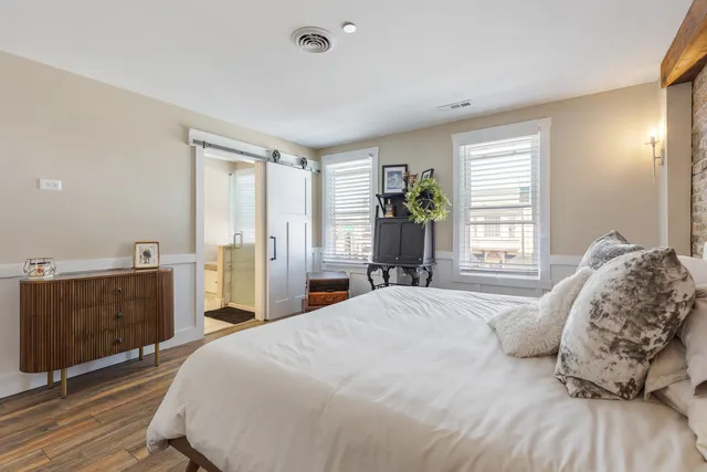 a bedroom with a bed and a dresser