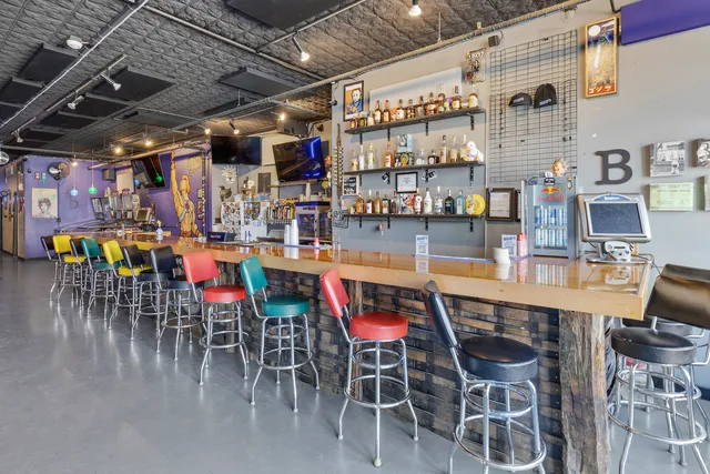 a dining area with lots of wooden furniture