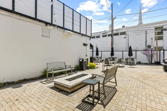 a view of a patio with a table and chairs