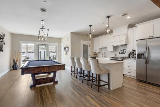 a kitchen with stainless steel appliances kitchen island hardwood floor and wooden floors
