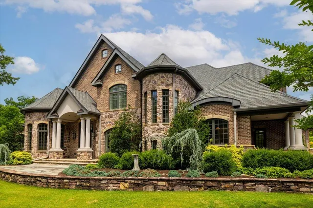 an aerial view of a house with garden space and street view