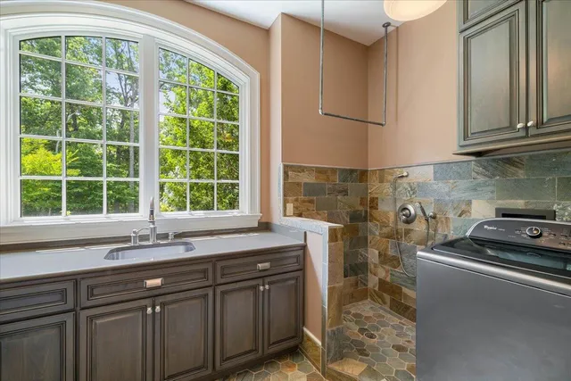 a bathroom with a granite countertop sink toilet and shower