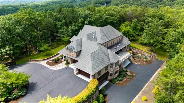 a large kitchen with stainless steel appliances a stove a sink dishwasher and a dining table with the living room view