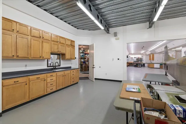 a spacious bedroom with a bed and a window