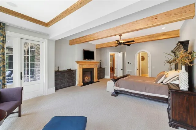 a front view of a house with a garden and trees