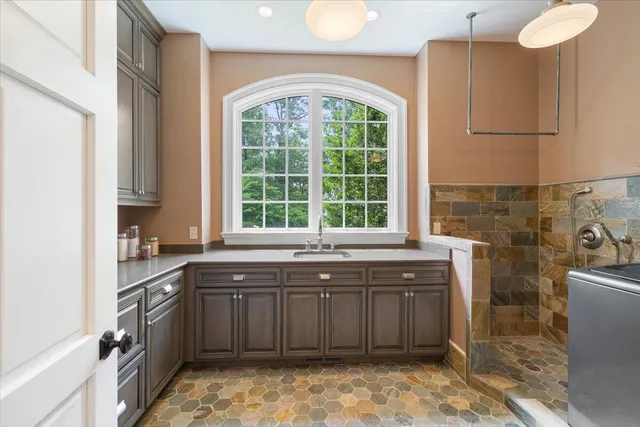 a kitchen with stainless steel appliances granite countertop a sink and cabinets