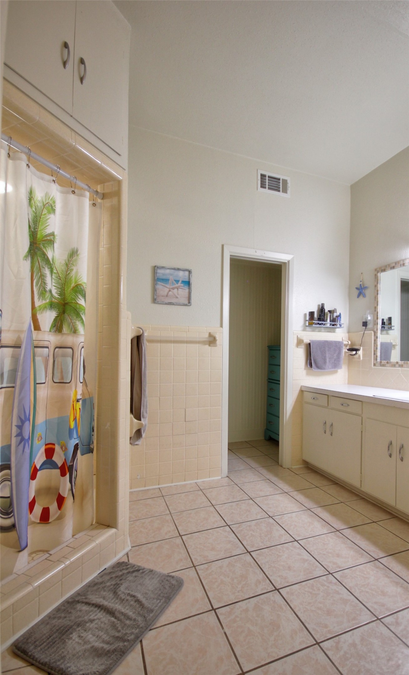 1504 Ranch Road 261 Buchanan Dam, TX 78609 - Photo 14 of 37 Bathroom featuring vanity, tile patterned flooring, tile walls, and curtained shower