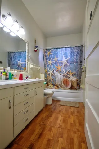 a bathroom with a bathtub sink and mirror