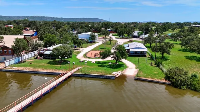 an aerial view of a house with a garden and lake view