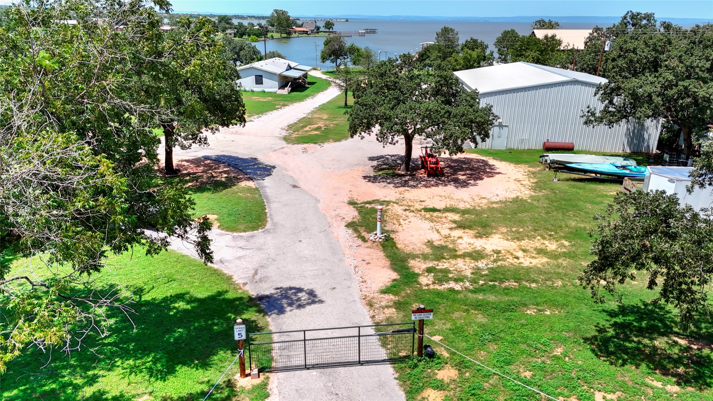 1504 Ranch Road 261 Buchanan Dam, TX 78609 - Photo 4 of 37 an aerial view of a house with a yard and lake view