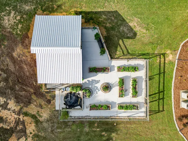 a view of a house with a yard and sitting area