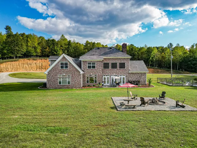a view of a house with swimming pool and sitting area