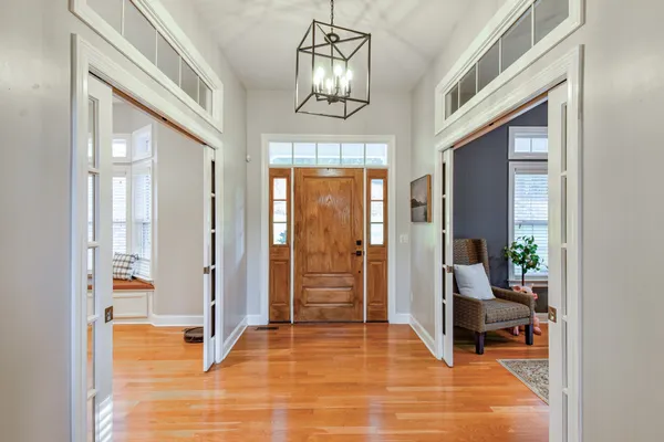 a bedroom with a bed and a refrigerator