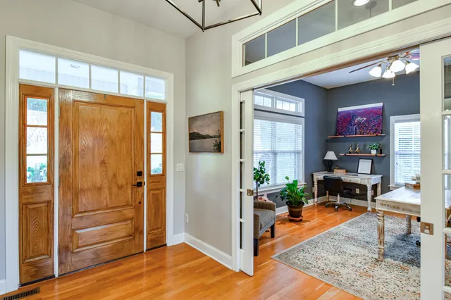 a bathroom with a granite countertop sink and a window