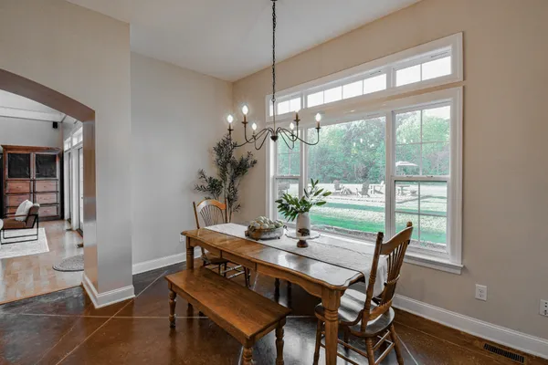 a spacious bathroom with a granite countertop sink a toilet a mirror and shower
