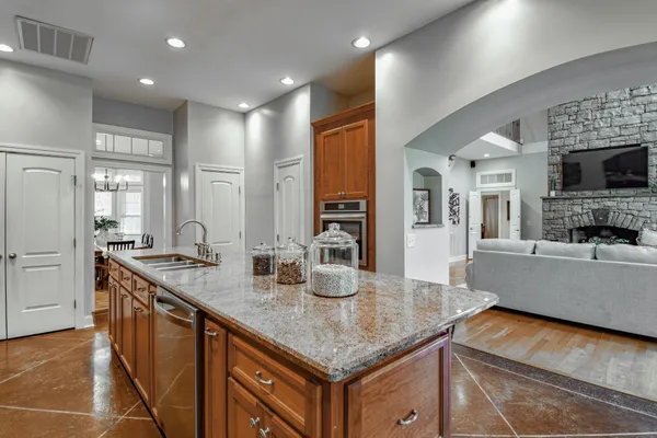 a living room with furniture and a chandelier