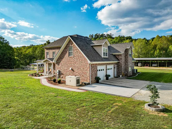 a view of a house with swimming pool and yard