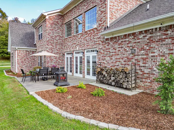 a view of a house with backyard porch and sitting area