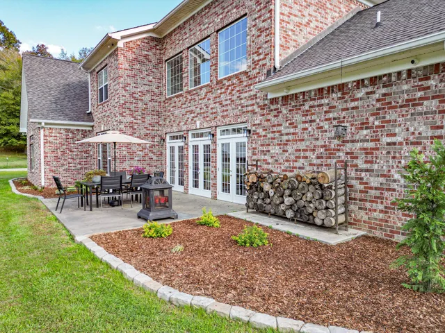 a view of a house with backyard porch and sitting area