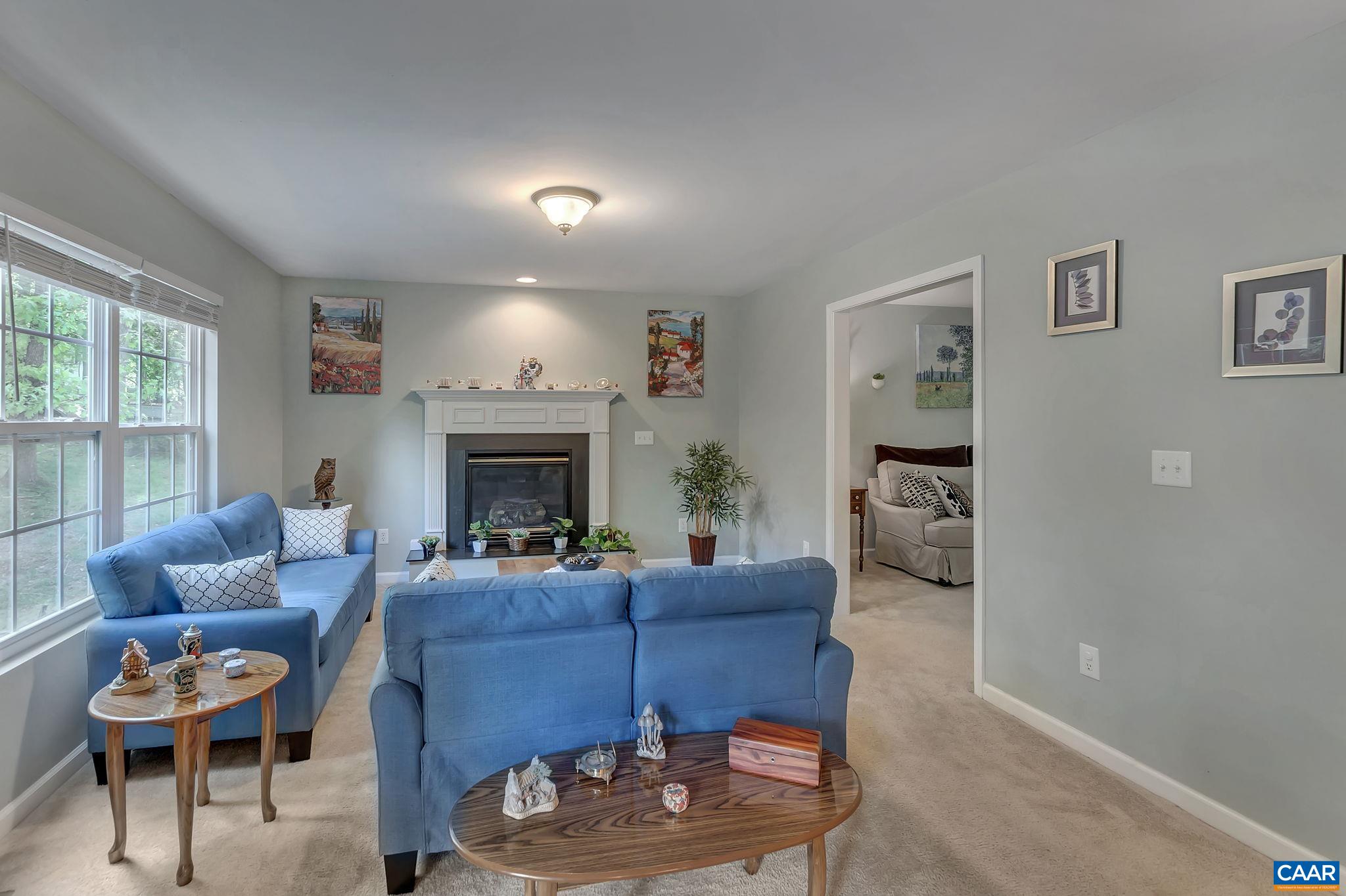 57 Amethyst Road Palmyra, VA 22963 - Photo 8 of 36 a living room with furniture a fireplace and a large window