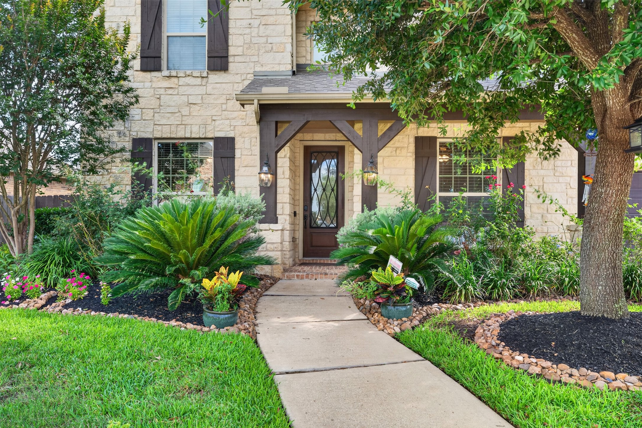18202 Wedgewood Bluff Court Spring, TX 77379 - Photo 2 of 50 Close-up of the front entry with decorative glass door and landscaped flower beds.