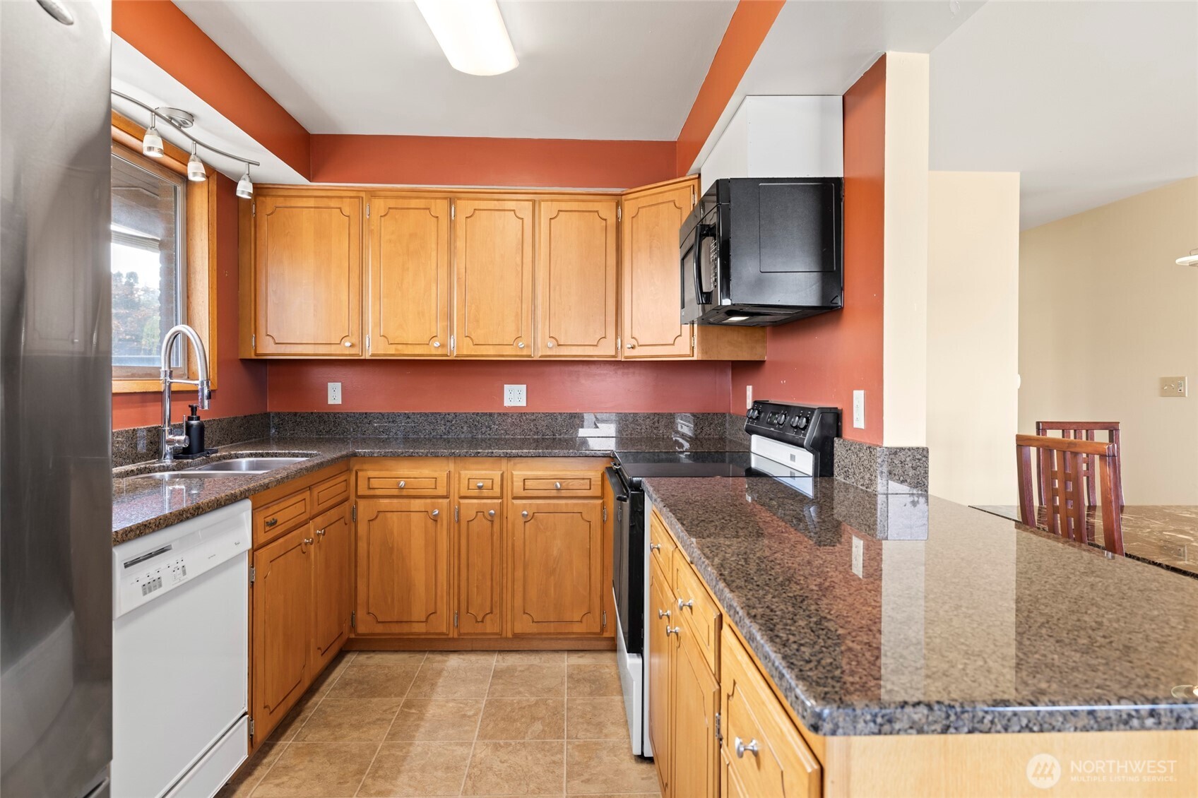 1307 26th Street Anacortes, WA 98221 - Photo 13 of 40 a kitchen with stainless steel appliances granite countertop a sink a stove counter space and cabinets