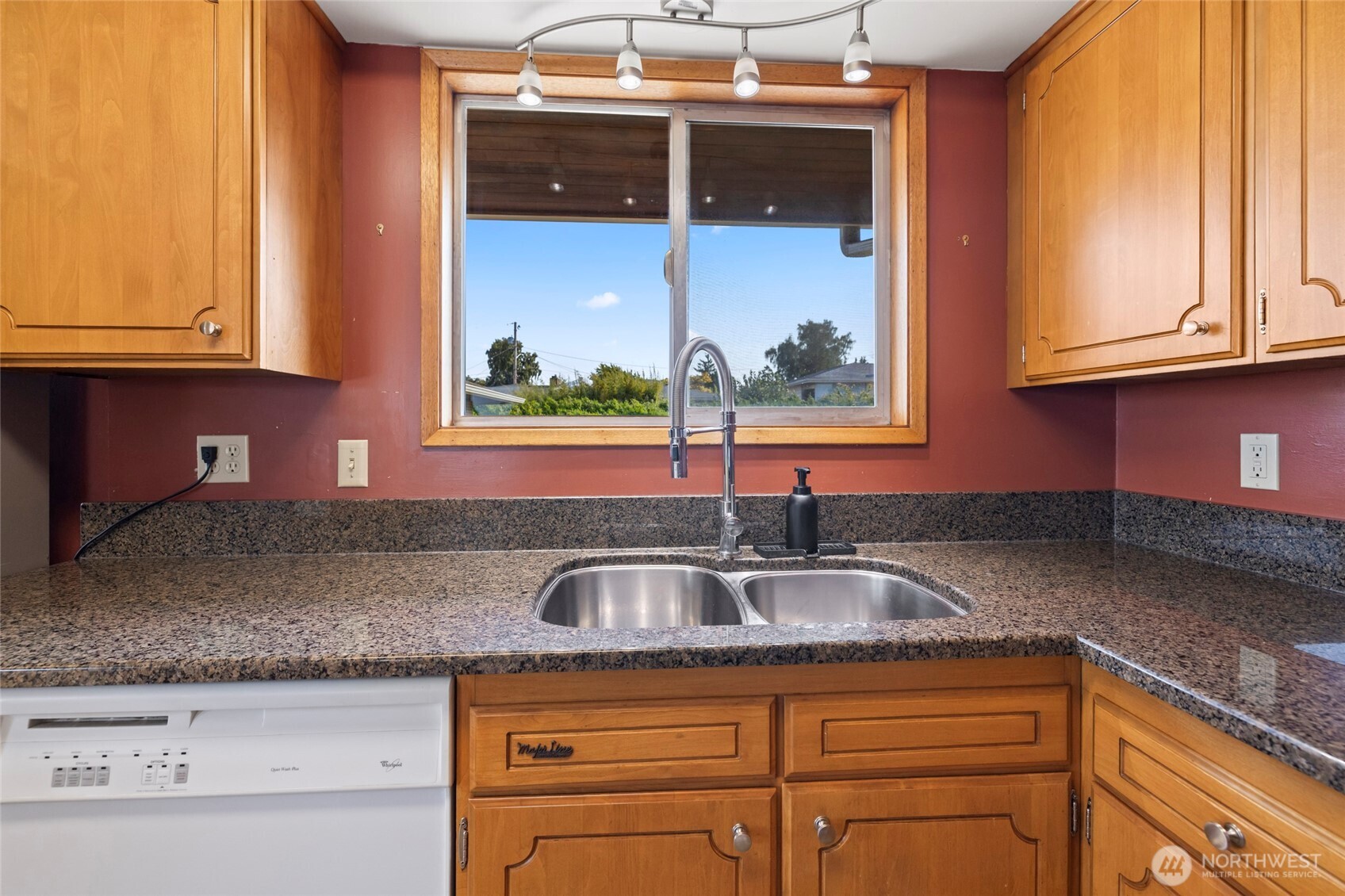 1307 26th Street Anacortes, WA 98221 - Photo 14 of 40 a kitchen with granite countertop a sink and cabinets