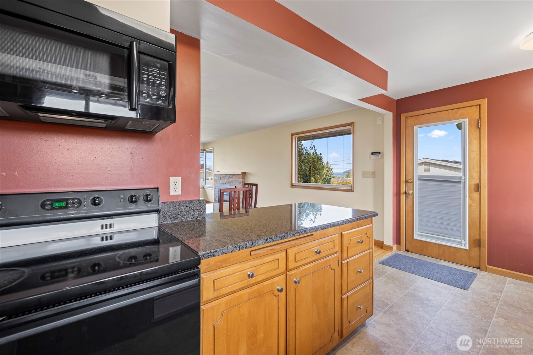 1307 26th Street Anacortes, WA 98221 - Photo 15 of 40 a kitchen with stainless steel appliances granite countertop a stove and a microwave